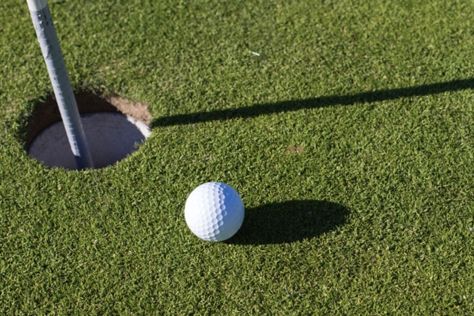 Putting green with a gold ball